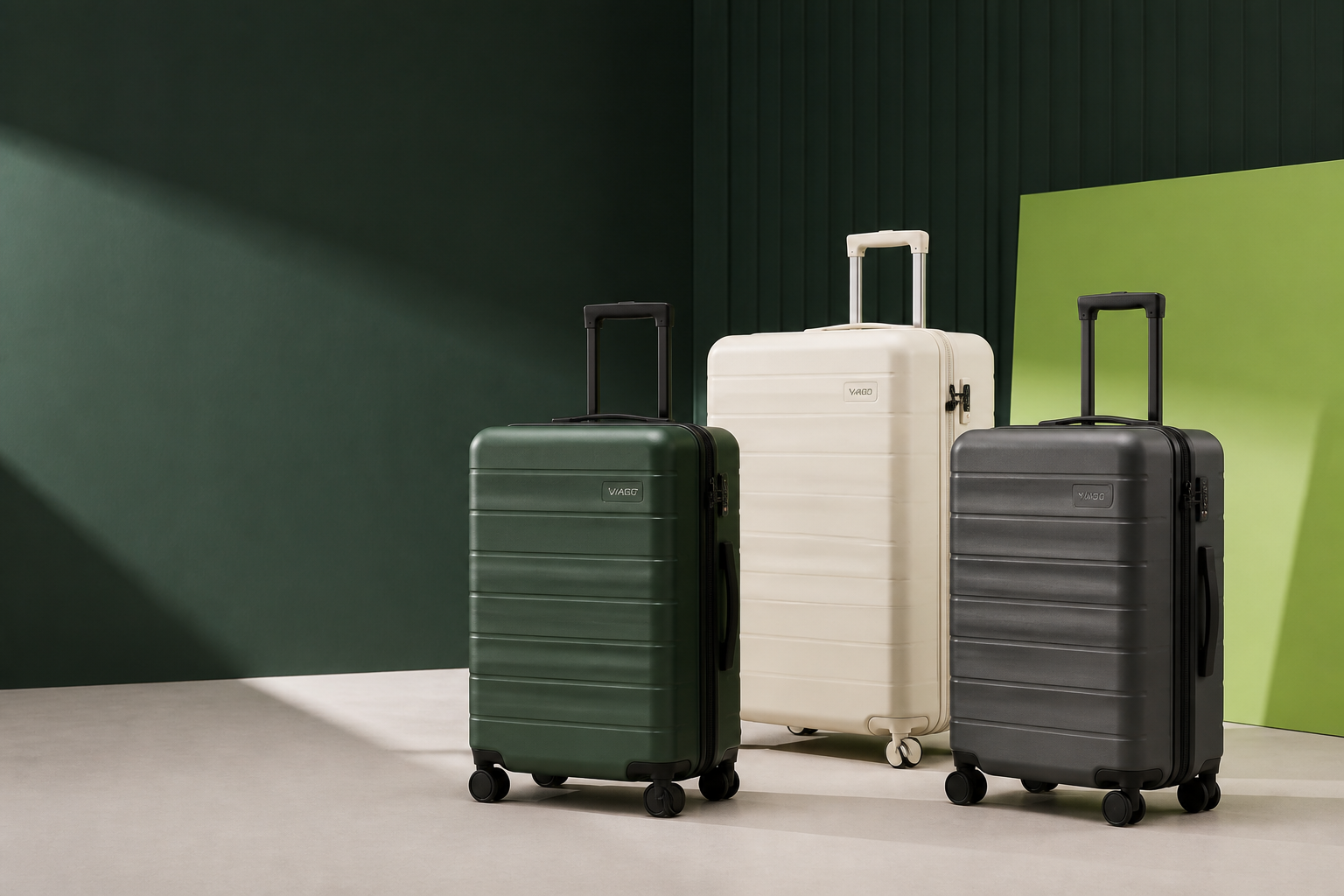Three VAGO hard-shell rolling suitcases in a studio display